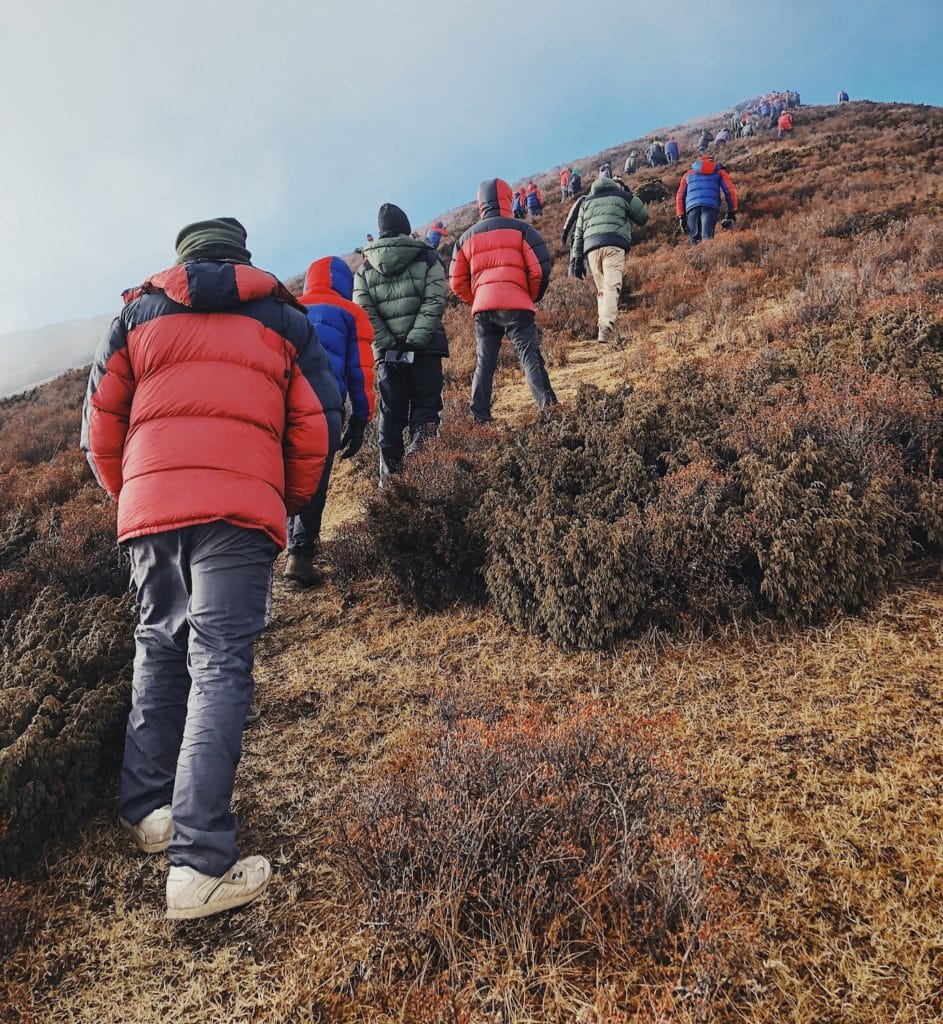 Walking to the summit of Dzongri Top, a Himalayan mountain viewpoint at 13,800 feet.